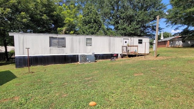 back of house with a wooden deck and a yard