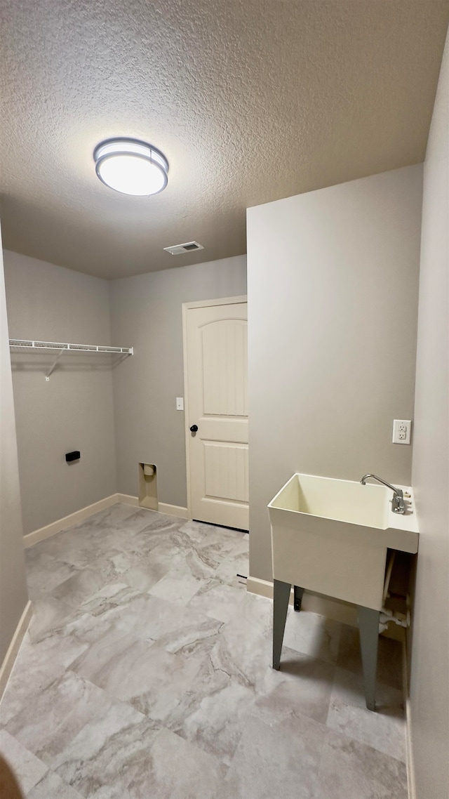 washroom with a textured ceiling