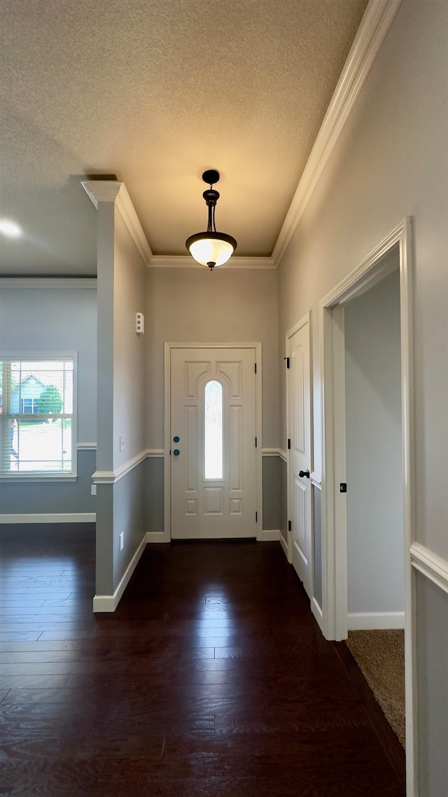 foyer with ornamental molding, a textured ceiling, and dark hardwood / wood-style floors