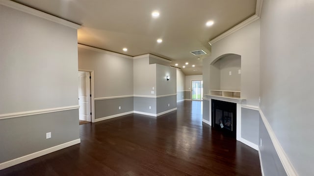 unfurnished living room featuring ornamental molding and dark hardwood / wood-style flooring