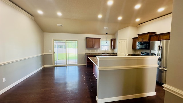 kitchen with hanging light fixtures, a center island, dark hardwood / wood-style floors, and stainless steel refrigerator with ice dispenser