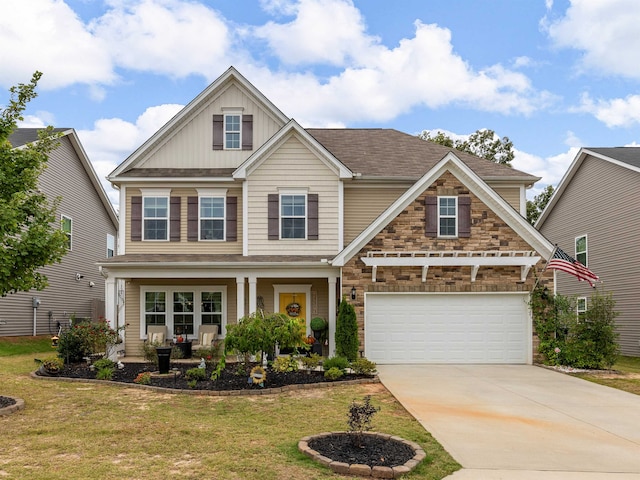 craftsman-style house with covered porch, a front yard, and a garage