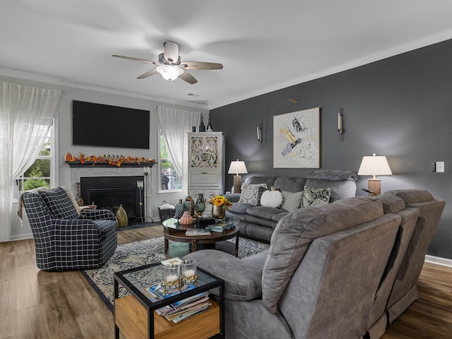 living room featuring ceiling fan, crown molding, and wood-type flooring