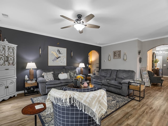 living room featuring crown molding, ceiling fan, and wood-type flooring