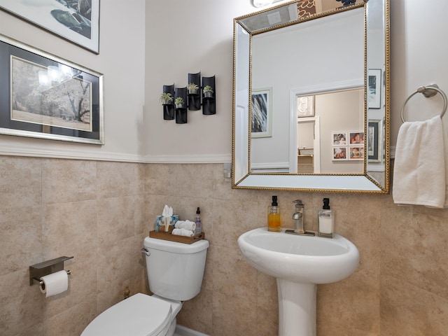 bathroom with tile walls, toilet, and tasteful backsplash