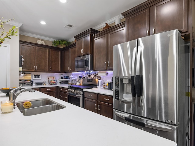 kitchen featuring dark brown cabinets, appliances with stainless steel finishes, ornamental molding, sink, and decorative backsplash