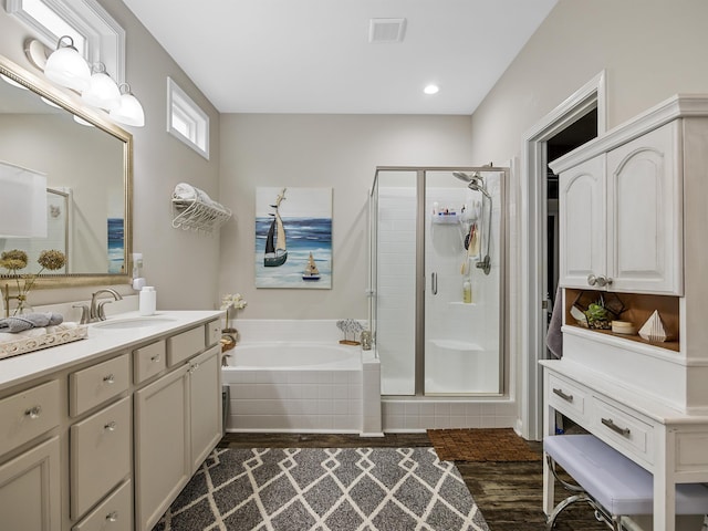 bathroom featuring hardwood / wood-style floors, separate shower and tub, and vanity