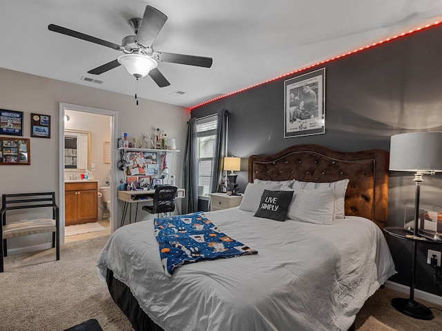 carpeted bedroom featuring ceiling fan and ensuite bathroom