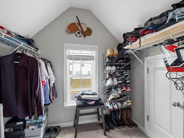 walk in closet featuring vaulted ceiling and carpet flooring