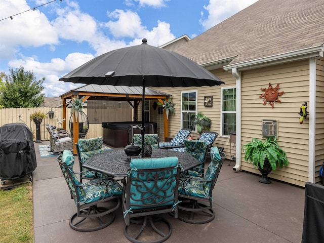 view of patio / terrace featuring a hot tub and area for grilling