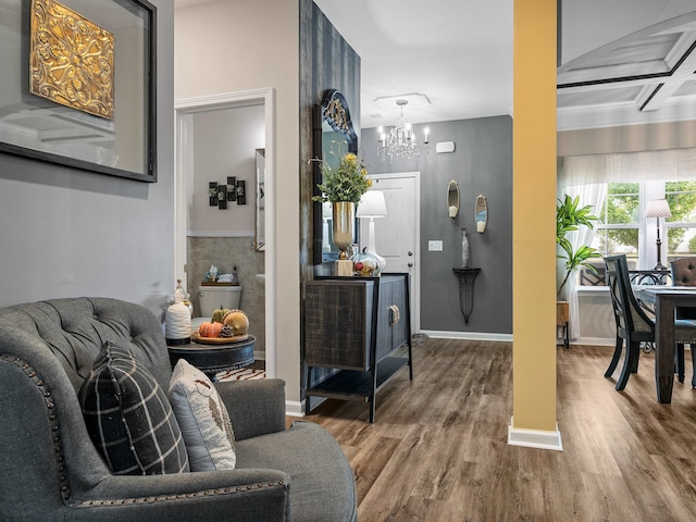 entryway with coffered ceiling, a notable chandelier, and wood-type flooring