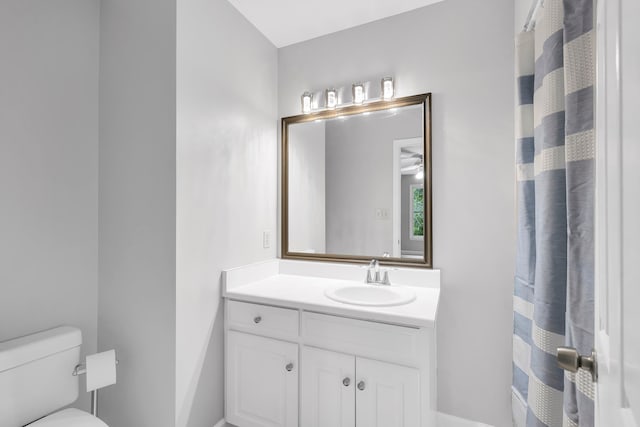 bathroom featuring vanity, ceiling fan, and toilet