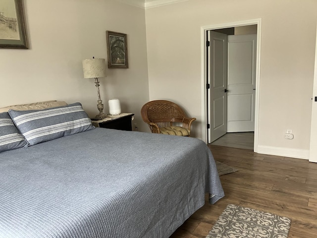 bedroom featuring dark hardwood / wood-style floors and crown molding