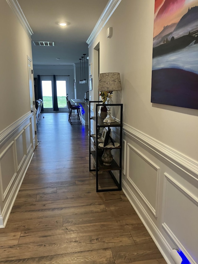 hallway with crown molding, dark wood-type flooring, and french doors