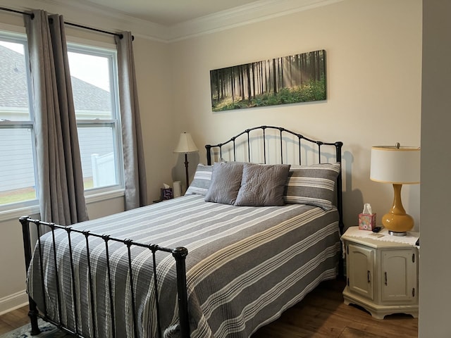 bedroom featuring dark wood-type flooring, multiple windows, and crown molding