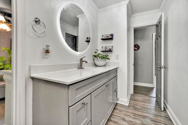 bathroom featuring wood-type flooring, vanity, and crown molding