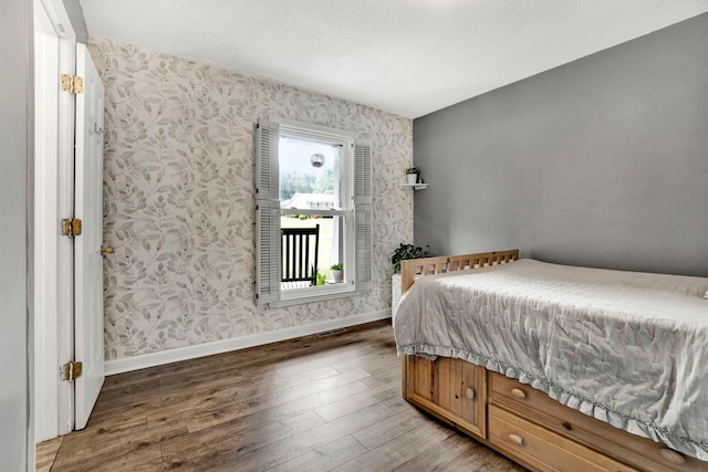 bedroom with hardwood / wood-style flooring