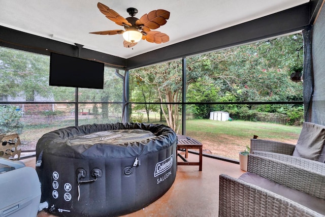 sunroom featuring ceiling fan