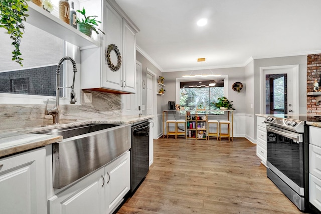 kitchen featuring sink, white cabinetry, stainless steel electric stove, light wood-type flooring, and black dishwasher