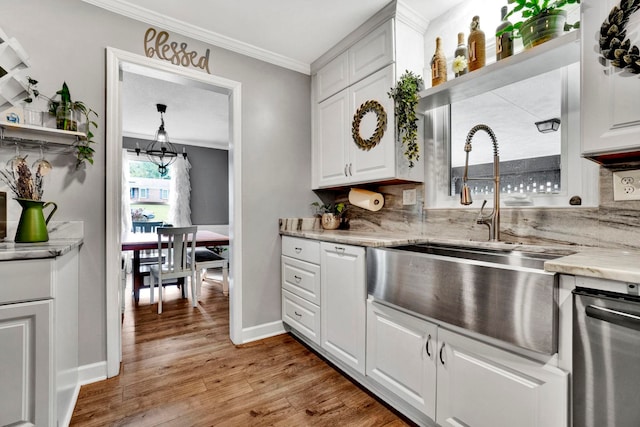 kitchen featuring light hardwood / wood-style flooring, white cabinets, and ornamental molding