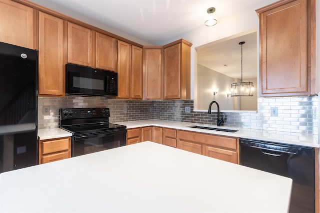 kitchen featuring hanging light fixtures, black appliances, decorative backsplash, and sink