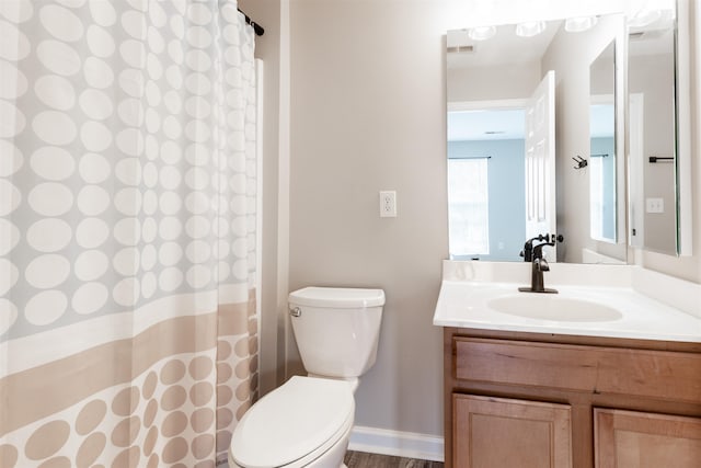 bathroom featuring vanity, toilet, and a shower with curtain