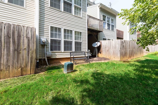 rear view of property featuring a yard