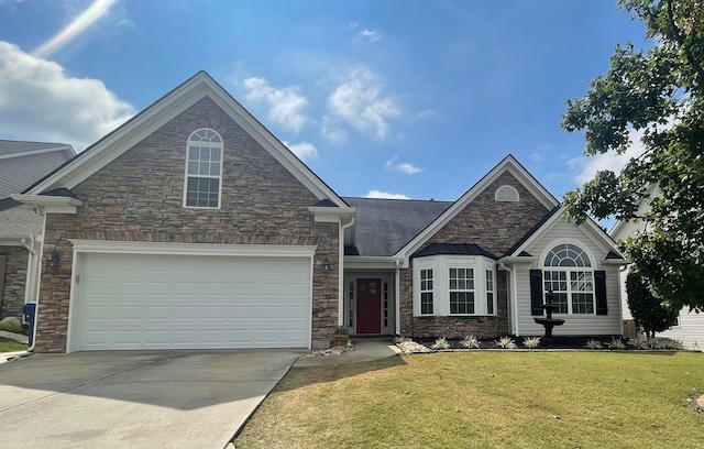 view of front of house featuring a front yard and a garage