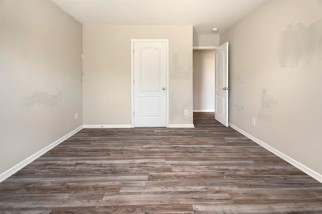 unfurnished bedroom featuring dark hardwood / wood-style flooring