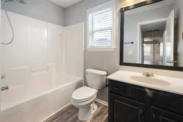 full bathroom featuring wood-type flooring, vanity, toilet, and bathtub / shower combination