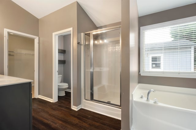 full bathroom with wood-type flooring, lofted ceiling, separate shower and tub, vanity, and toilet