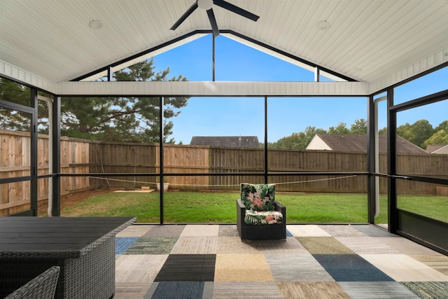 unfurnished sunroom with vaulted ceiling and ceiling fan