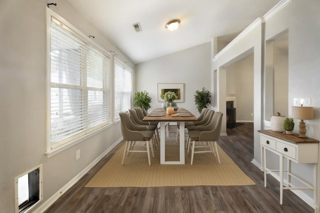 dining room with lofted ceiling and dark hardwood / wood-style flooring