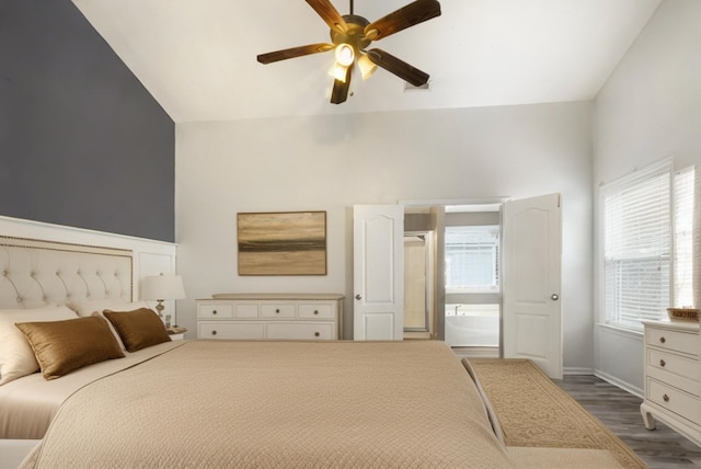 bedroom featuring vaulted ceiling, dark hardwood / wood-style floors, and ceiling fan