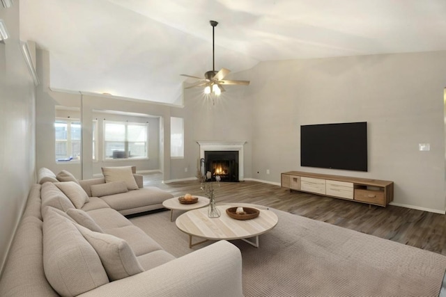 living room featuring ceiling fan, lofted ceiling, and dark hardwood / wood-style flooring