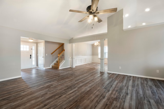 unfurnished living room with ceiling fan with notable chandelier and dark hardwood / wood-style floors