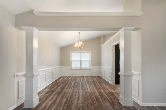 spare room featuring a notable chandelier, vaulted ceiling, decorative columns, and dark hardwood / wood-style flooring