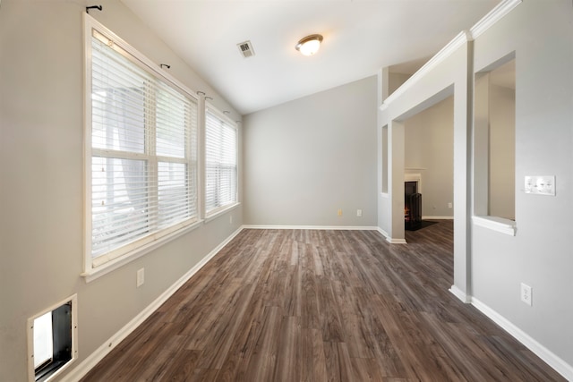 empty room with lofted ceiling and dark hardwood / wood-style floors