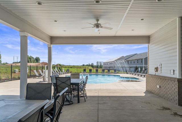 view of swimming pool with ceiling fan and a patio area