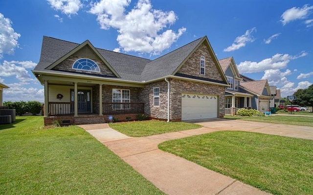 view of front of home featuring a front yard, cooling unit, and covered porch