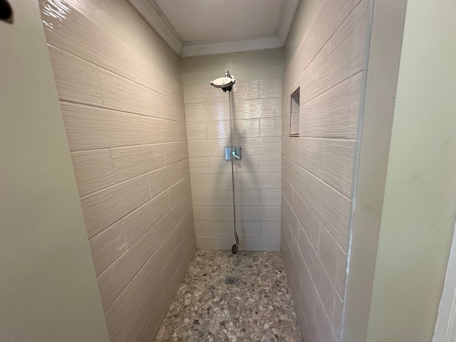 bathroom with ornamental molding, tile walls, and a shower