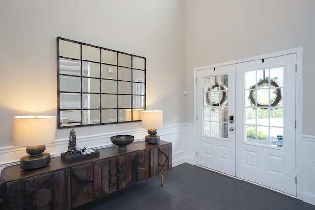 foyer entrance with french doors and dark wood-type flooring