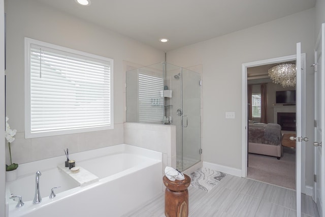 bathroom with independent shower and bath, plenty of natural light, and tile patterned flooring