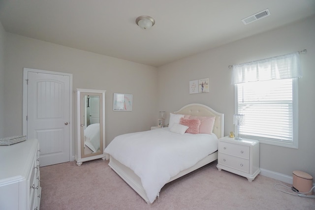 bedroom with light colored carpet