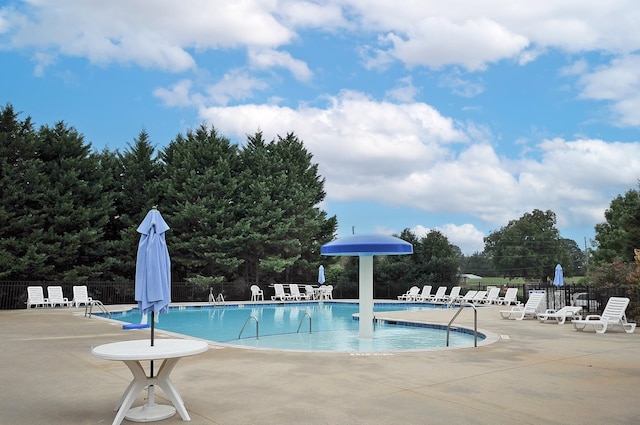 view of swimming pool with a patio area