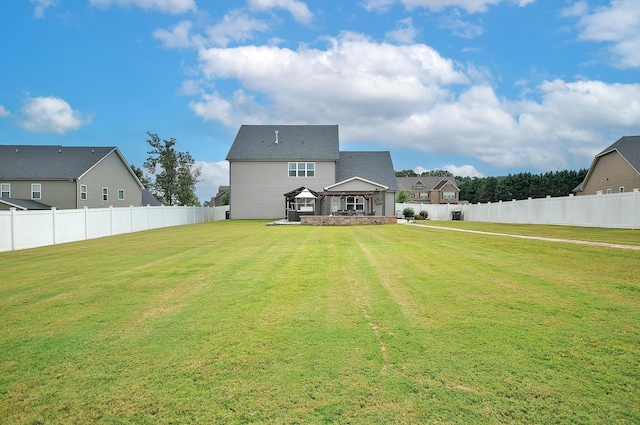 rear view of property with a yard