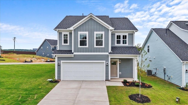 view of front of house featuring a front lawn, central air condition unit, and a garage