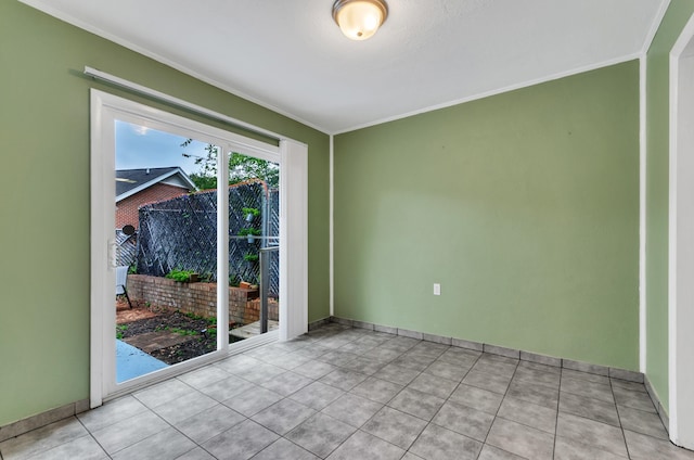 empty room featuring light tile patterned floors and ornamental molding