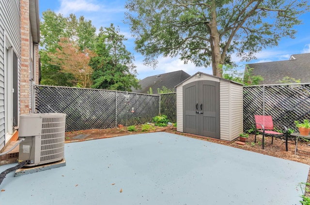 view of patio / terrace with a storage shed and central AC