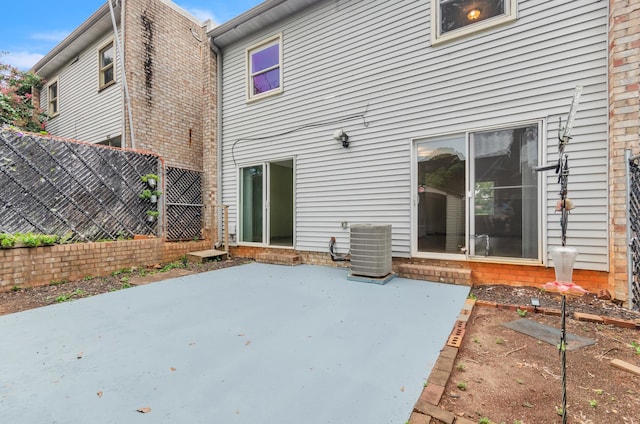 back of property with cooling unit and a patio area